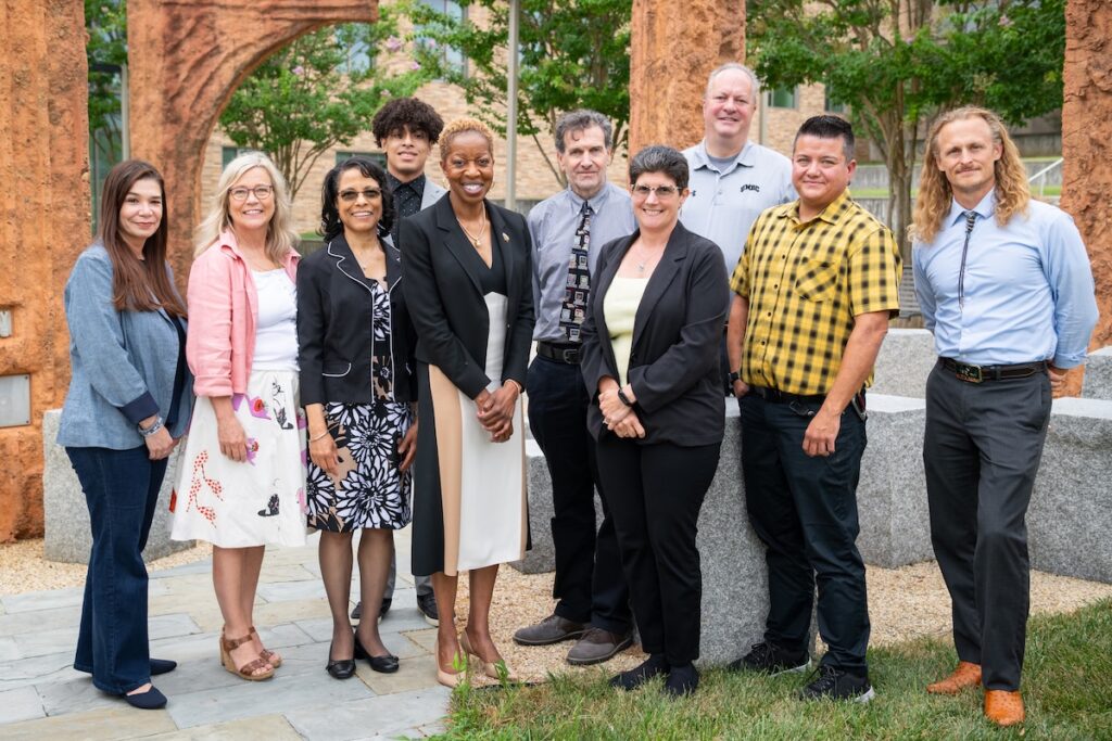 Seven USC members with President Sheares Ashby